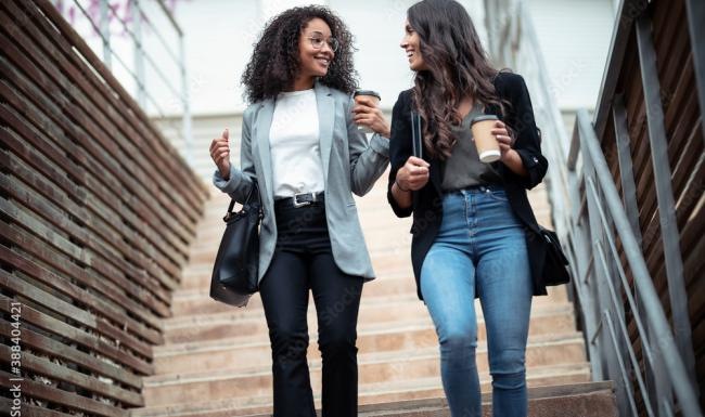 a couple of women walking down a flight of stairs