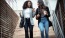a couple of women walking down a flight of stairs